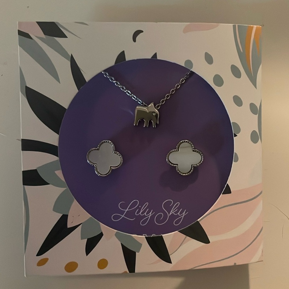 Lily Sky earrings and elephant necklace.